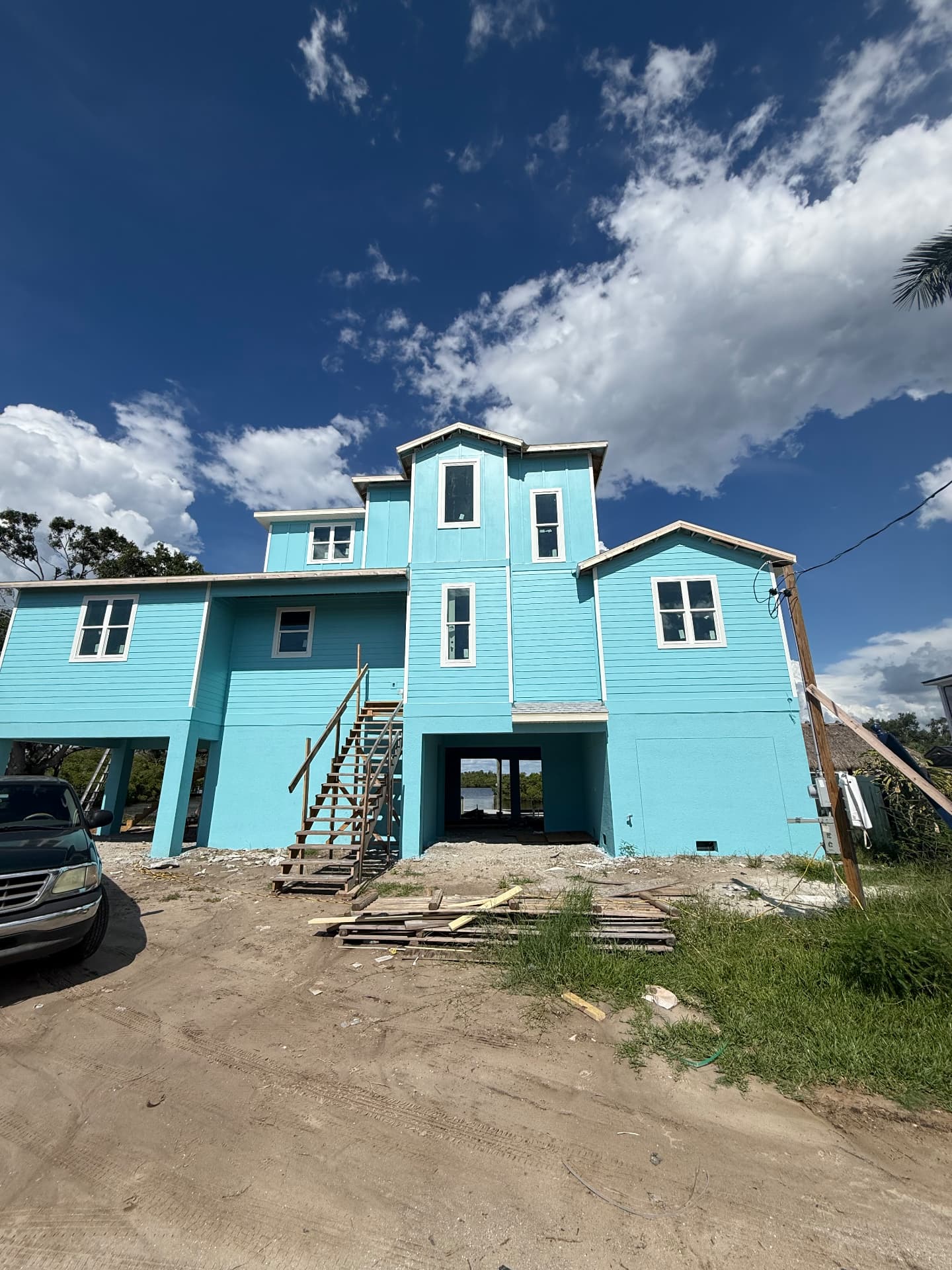 Coastal three-story home with painted siding and stucco base